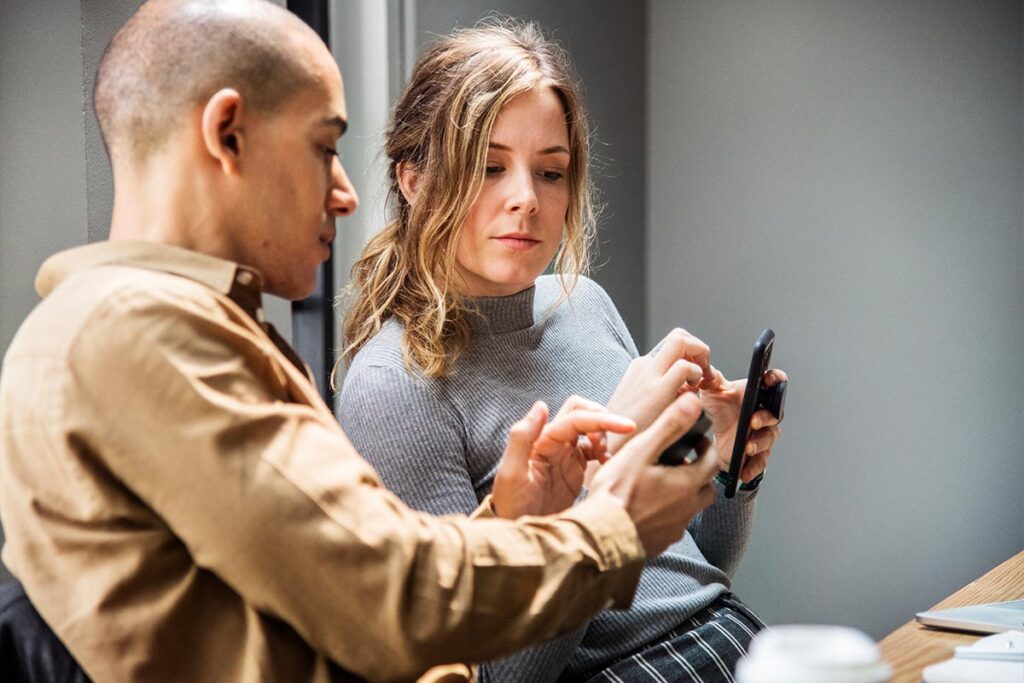 A man and woman discussing something they saw online